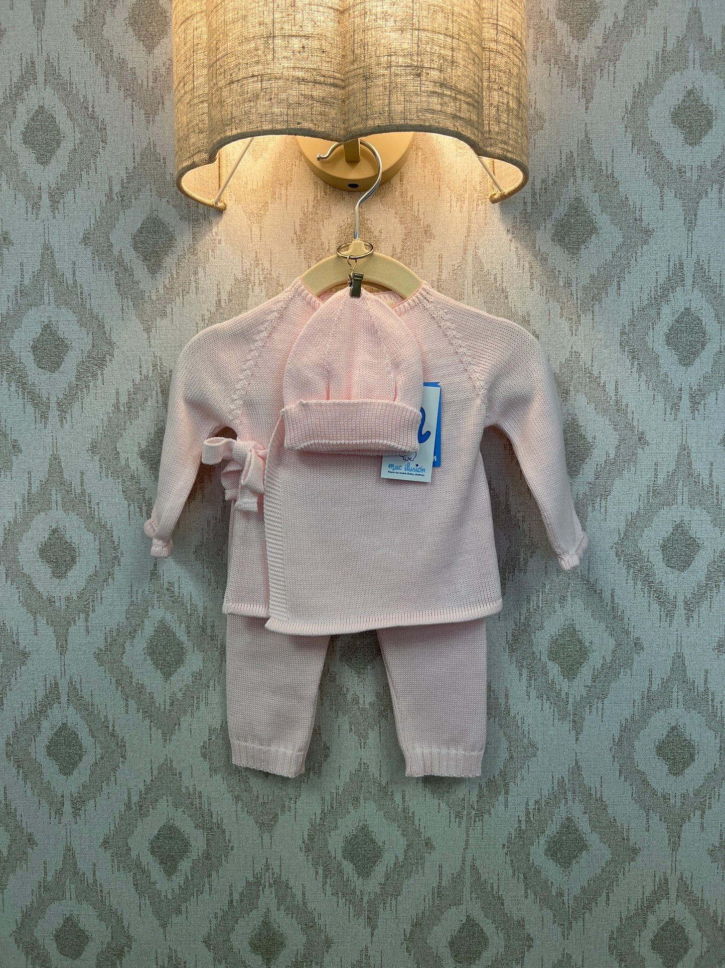 Baby three-piece outfit includes knitted sweater, leggings and hat